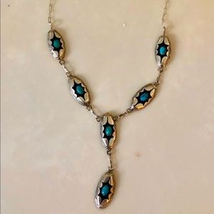 Sterling silver with turquoise. This is very unique very beautiful on. Like new